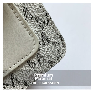 Detail of lychee textured cream leather with black dotted letter print and stitching