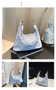 Blue pleated tote bag featuring decorative white beads and gold metal hooks