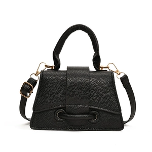 Minimalist black lychee pattern trapezoid handbag with gold hardware and top handle