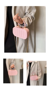 Close-up of pink quilted crossbody bag with woven handle and gold chain strap