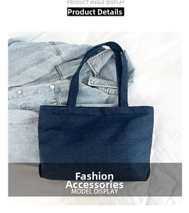 Detailed view of large dark blue denim tote bag with visible twill fabric texture