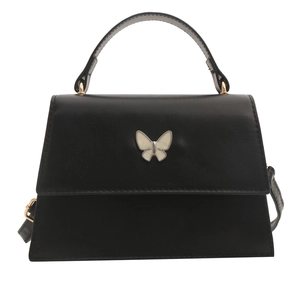 Black minimalist trapezoid handbag with a white butterfly ornament and top handle strap