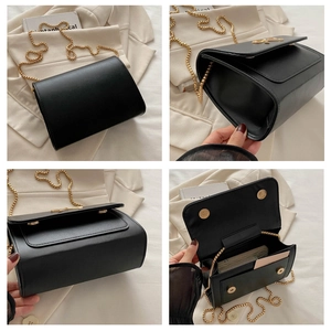 Detail showing black leather crossbody bag with golden bow clasp and chain strap features