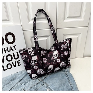 Detail of vintage skull and purple floral print on black canvas tote bag