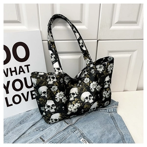 Detail of canvas tote bag with white skull and floral print on black background