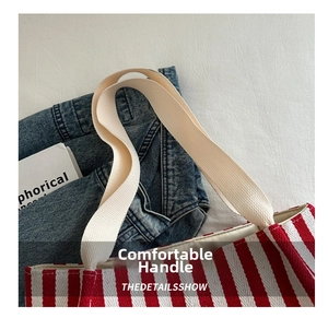 Close-up of red and white striped tote bag showing durable canvas and woven handles