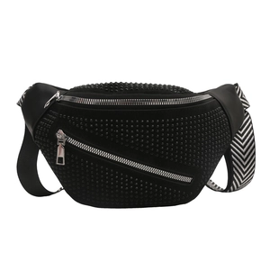 Black studded crossbody bag with silver zippers and wide black-white patterned strap