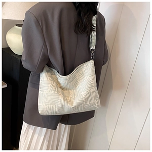 Green striped canvas tote bag detail on shoulder with broad strap and silver hardware