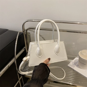 Minimalist white trapezoidal handbag with lychee pattern leather and top handles for women