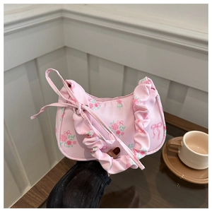 Détail du sac en toile à fleurs roses avec bordure à volants et nœud décoratif