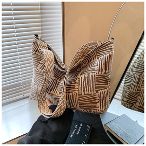 Detailed macro view of large woven tote bag with ethnic patterns and wide jacquard strap