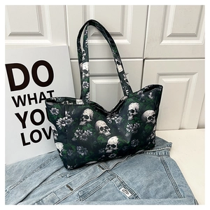 Macro detail of large gothic tote bag featuring white skull and floral print on canvas
