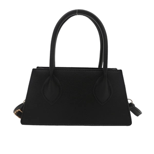 Minimalist black trapezoid handbag for women featuring a curved handle and lychee texture