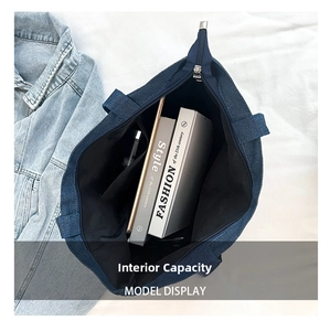 Detailed internal view of large capacity denim tote bag with inner pocket and zipper