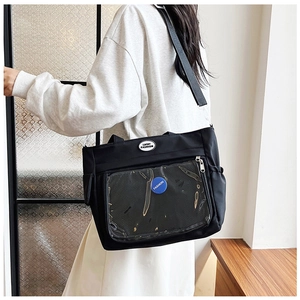 Detail of black tote bag with transparent PVC front pocket and Lucky Fashion logo