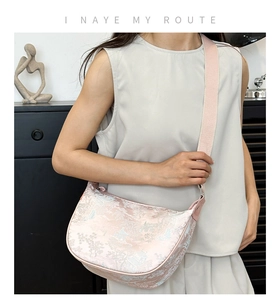 Detail of light pink jacquard silk bag with Chinese mountain and water landscape print