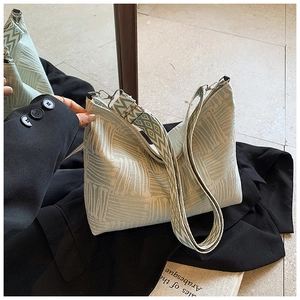 Detail view of mint green jacquard tote bag with wide geometric patterned shoulder strap