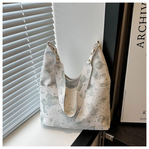 Vue détaillée du sac cabas à imprimé papillon avec rivets dorés et bandoulière