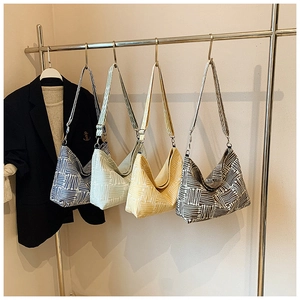 Detail of canvas crossbody bags in four colors with white geometric pattern prints