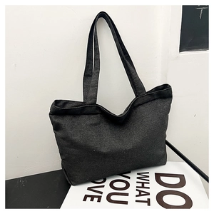 Close-up of deep gray canvas tote bag featuring high-capacity design and thick fabric texture