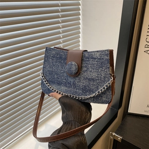 Denim tote bag with silver rhinestones and brown leather strap for fashion commuting