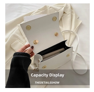 Internal capacity of white leather crossbody bag showing space for a smartphone