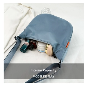 Detail of blue crescent bag interior showing spacious storage for cosmetics and essentials