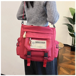 Vista posteriore di una persona con borsa a tracolla in nylon rosso a grande capacità