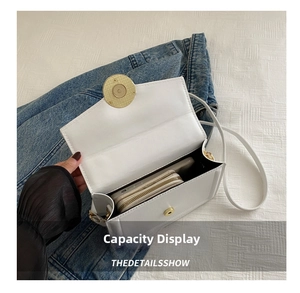 Internal view of the white leather crossbody bag showing capacity for wallet and smartphone