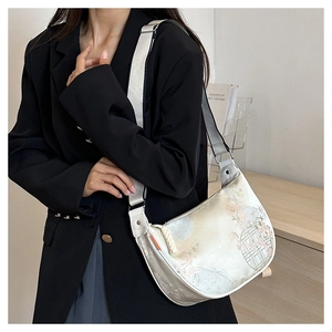 Detail of floral oriental pattern silk tote bag with wide strap on a female model
