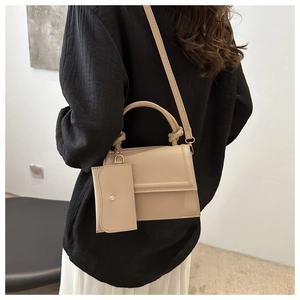 Detailed view of the apricot PU leather crossbody bag featuring a unique knotted handle
