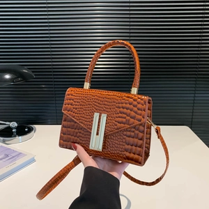 Brown crocodile pattern faux leather handbag with gold bar clasp and adjustable strap