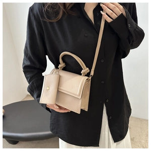 Chic beige crossbody square bag with a matching mini pouch and knotted top handle detail