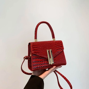 Elegant red crocodile texture crossbody bag with gold buckles and top handle design