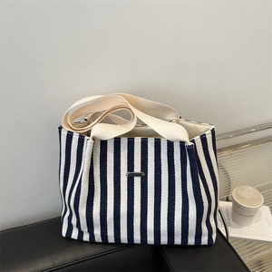 Large capacity striped navy and white canvas tote bag with wide cream handles for commuting