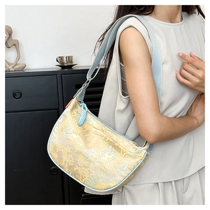 Detail of silk jacquard fabric and light blue trim on a vintage Chinese style shoulder bag