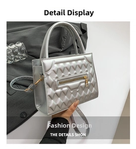 Close-up of silver quilted crossbody bag with metallic finish and zipper detail