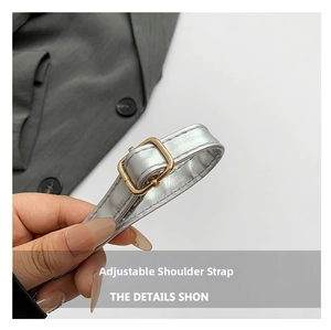 Detailed close-up of adjustable silver shoulder strap with premium golden metal buckle