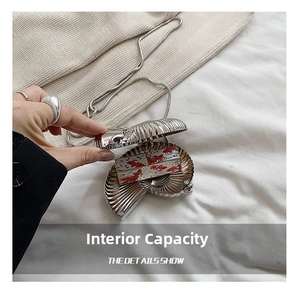 Detailed internal view of silver nautilus shell evening bag with metal chain strap