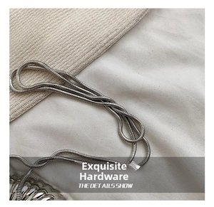 Close-up of a glossy silver snake chain strap with smooth metallic texture for bags