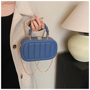 Detailed view of Morandi blue box bag with vertical texture and spiral handle design