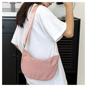 Pink waterproof nylon half-moon crossbody bag with adjustable wide fabric shoulder strap