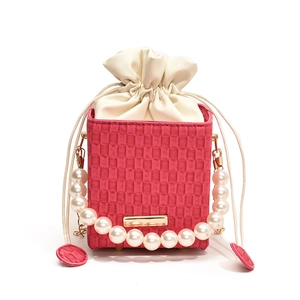 Pink checkered box handbag with pearl chain handle and cream drawstring pouch