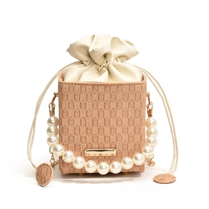 Elegant apricot woven square crossbody bag with pearl strap and drawstring closure