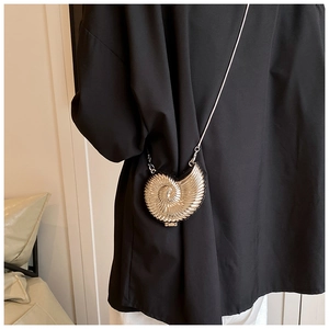 Sleek metallic shell shaped crossbody bag with elegant spiral texture and chain strap