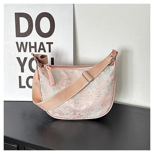 Detailed embroidery of Chinese landscape on pink crescent bag with woven zipper puller