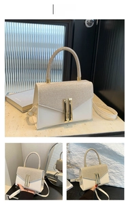Detail of champagne gold sequined handbag with ivory faux leather and metal clasp