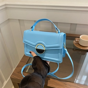 Light blue retro crossbody bag with golden round buckle and sleek handle in soft leather