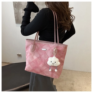 Pink quilted tote bag detail with slim straps and a cute white cloud plush pendant