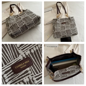 Detail of striped jacquard tote bag showing large capacity for books and golden hardware